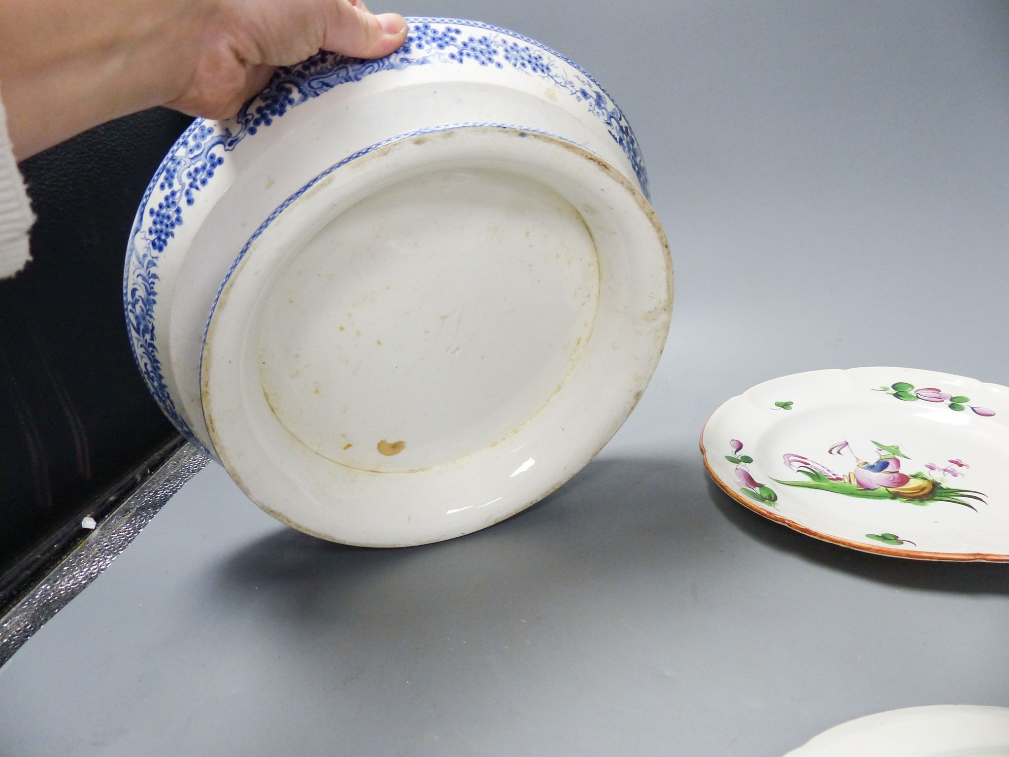 An ironstone cheese stand and a pair of French faience plates 30cm